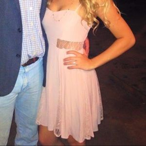 Blush pink dress with lace cutouts.